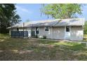 The home features neutral siding, a metal roof, and a small front porch at 11141 Rex Hunter Ln, Lithia, FL 33547
