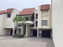 This building's exterior includes a Spanish-style roof, well-kept landscaping and garage parking at 120 1St E St # 104, St Petersburg, FL 33715
