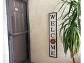 Inviting front entrance with a 'Welcome' sign and a decorative plant, providing a warm and welcoming atmosphere at 120 1St E St # 104, St Petersburg, FL 33715