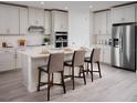 Bright kitchen with white cabinetry, stainless steel appliances, subway tile and a large center island at 1856 Draughton Dr, Zephyrhills, FL 33541