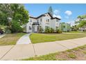 Two-story home features black and white accents and an inviting front yard at 2306 Trelain S Dr, St Petersburg, FL 33712