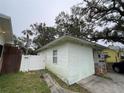 Side view of the home showing its simple structure, small window, and access to a fenced backyard at 2900 Dr Martin Luther King Jr S St, St Petersburg, FL 33705