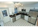Updated kitchen features stainless steel appliances and sleek white cabinetry at 300 6Th N St # E3, Safety Harbor, FL 34695