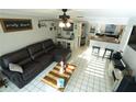 Cozy living room with tile floors, ceiling fan, and open layout to kitchen at 300 6Th N St # E3, Safety Harbor, FL 34695
