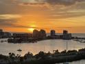 City skyline view at sunset, with silhouetted buildings reflecting the golden light over the water at 31 Island Way # 1403, Clearwater Beach, FL 33767