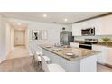 Bright, open kitchen featuring granite countertops, stainless steel appliances, and a stylish breakfast bar at 3529 Thistle Bank Ct, Plant City, FL 33565