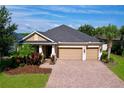Charming single-story home showcasing a brick driveway and two car garage at 3643 Arbor Chase Dr, Palm Harbor, FL 34683