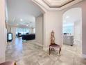 Well-lit foyer with tile flooring, showcasing the open floor plan and stylish decor at 3643 Arbor Chase Dr, Palm Harbor, FL 34683