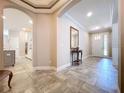 Inviting foyer featuring tile flooring, archways, and a decorative table with mirror at 3643 Arbor Chase Dr, Palm Harbor, FL 34683