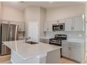 Modern kitchen featuring stainless steel appliances, a large island, and white cabinetry at 37155 Sagemoor Dr, Zephyrhills, FL 33541