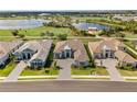 Panoramic aerial view showcases the home's prime location near a golf course, lake, and other luxury homes at 3888 Santa Caterina Blvd, Bradenton, FL 34211