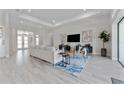 Spacious living room with modern furnishings, gray flooring, recessed lights and an open floor plan at 3888 Santa Caterina Blvd, Bradenton, FL 34211