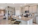 Modern kitchen with granite countertops, stainless steel appliances, and a breakfast bar with seating at 4027 Harvest Hearth Pl, Plant City, FL 33565