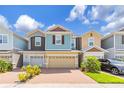Charming multi-colored townhome featuring a brick driveway, attached garages, and well-maintained landscaping at 4316 Sailplane Ct, Wesley Chapel, FL 33545