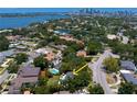Panoramic aerial view of a neighborhood with mature trees, nearby bodies of water, and city skyline at 444 W Davis Blvd, Tampa, FL 33606