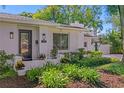 Inviting entryway with black framed door, lush landscaping and a white exterior at 444 W Davis Blvd, Tampa, FL 33606