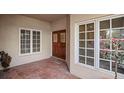 Inviting front porch with a decorative wood door, large windows, and tiled flooring at 4941 Bayshore Blvd, Tampa, FL 33611