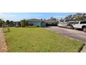 Charming home with a lush green lawn, well-maintained landscaping, and ample parking at 6530 Manila Palm Way, Apollo Beach, FL 33572