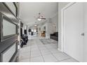Bright, open-concept living area with tile flooring and a view of the dining and kitchen spaces at 6623 Northhaven Ct, Riverview, FL 33578