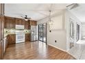 Well-lit kitchen features stainless steel appliances, wood cabinets, and a stylish backsplash at 706 1St Ct, Palm Harbor, FL 34684
