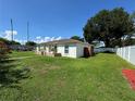 Well-maintained home shows off its spacious yard and modern fence, perfect for outdoor enjoyment at 7102 Reindeer Rd, Tampa, FL 33619