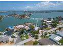 Waterfront home with beautiful landscaping, a private dock, and an inviting pool, offering serene water views at 719 59Th Ave, St Pete Beach, FL 33706
