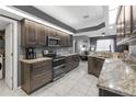 Modern kitchen featuring granite countertops, stainless steel appliances, and ample cabinet space at 7246 Julian St, New Port Richey, FL 34653