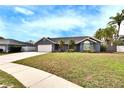 Charming single-story home with well-maintained lawn and attached garage under a sunny blue sky at 728 Camrose Dr, Brandon, FL 33510