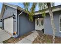 Inviting front entrance featuring double doors, side lights, and well-kept landscaping, leading to a charming home at 728 Camrose Dr, Brandon, FL 33510