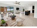 Open-concept living room with tile floors, stylish furniture, and a view of the fenced backyard at 8452 Silverbell Loop, Brooksville, FL 34613