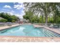 Inviting community pool with brick patio and lounge chairs at 11304 Cayman Key Ave # 2, Tampa, FL 33624
