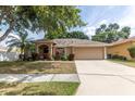 Lovely single-Gathering home featuring a driveway and well-manicured front lawn at 11416 Wellman Dr, Riverview, FL 33578