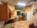 Kitchen with stainless steel appliances, granite counters, tile floors and wooden cabinets at 11416 Wellman Dr, Riverview, FL 33578