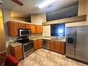 Kitchen with stainless steel appliances, granite counters, tile floors and wooden cabinets at 11416 Wellman Dr, Riverview, FL 33578