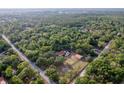 Breathtaking aerial perspective of a luxurious property, complete with a sparkling pool, expansive land, and a home at 12311 Oakwood Dr, Hudson, FL 34669