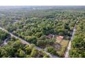 Serene aerial shot of a home nestled in a lush, green landscape, featuring a barn, pool, and a large yard at 12311 Oakwood Dr, Hudson, FL 34669