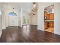 Spacious living area featuring a soaring ceiling, elegant lighting, and a seamless connection to the kitchen at 12421 Seabrook Dr, Tampa, FL 33626