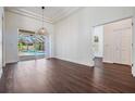 Bright, open living room with dark hardwood flooring, a sliding glass door and access to the pool at 12421 Seabrook Dr, Tampa, FL 33626