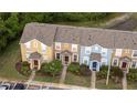 Aerial view of townhomes with well-maintained lawns, landscaping, and ample parking at 1250 Charlesworth Dr, Wesley Chapel, FL 33543