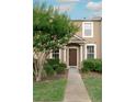 Inviting townhouse entrance with manicured landscaping and a charming covered porch at 1250 Charlesworth Dr, Wesley Chapel, FL 33543