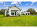 Charming two-story home featuring a manicured lawn, attached three car garage, and covered porch at 13711 Lussier Ln, Spring Hill, FL 34610