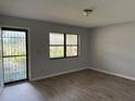 Inviting entryway with storm door, large window, and wood-look vinyl flooring at 13742 14Th St, Dade City, FL 33525