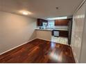Open kitchen featuring stainless steel appliances, granite counters and warm wood cabinets at 14446 Reuter Strasse Cir # 3, Tampa, FL 33613