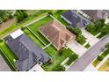 Aerial view of a well-maintained home with a manicured lawn and a fenced backyard in a quiet neighborhood at 17516 Bright Wheat Dr, Lithia, FL 33547