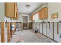 Unfinished kitchen with concrete block and wood frame and wood cabinetry at 1801 Mississippi Ne Ave, St Petersburg, FL 33703
