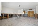 Unfinished living room with concrete block and wood frame leading to kitchen area at 1801 Mississippi Ne Ave, St Petersburg, FL 33703