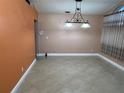 Bright dining area featuring tiled floors, neutral walls, decorative curtains, and a stylish light fixture at 18104 Sweet Jasmine Dr, Tampa, FL 33647