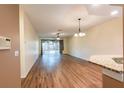 Spacious living room features wood floors, ceiling fan, and sliding doors to the lanai at 19025 Callaway Ct, Tampa, FL 33647