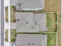 An aerial view of the home showcasing the roof, yard, and proximity to neighboring houses at 22294 Storybook Cabin Way, Land O Lakes, FL 34637