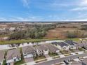 A street view showcases houses near a pond, highlighting community living and serene natural surroundings at 22294 Storybook Cabin Way, Land O Lakes, FL 34637